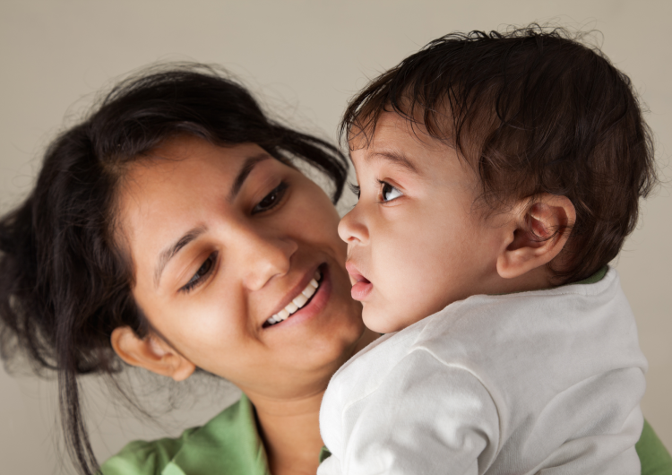 a young mum looking lovingly at her baby