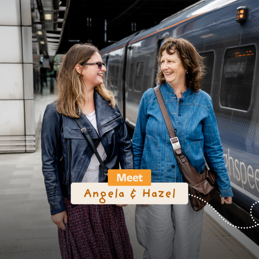 a mum and her adult daughter walking through a train station