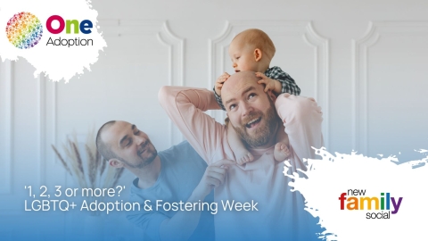 A male couple carrying their baby on shoulders and laughing up at them
